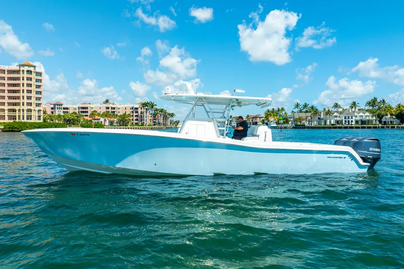 Slide: The Image of 2016 Invincible 39 boat cruising on clear blue water under a sunny sky. - 5