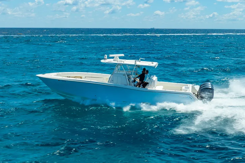 Slide: The Image of 2016 Invincible 39 boat cruising on open blue ocean under clear sky. - 6