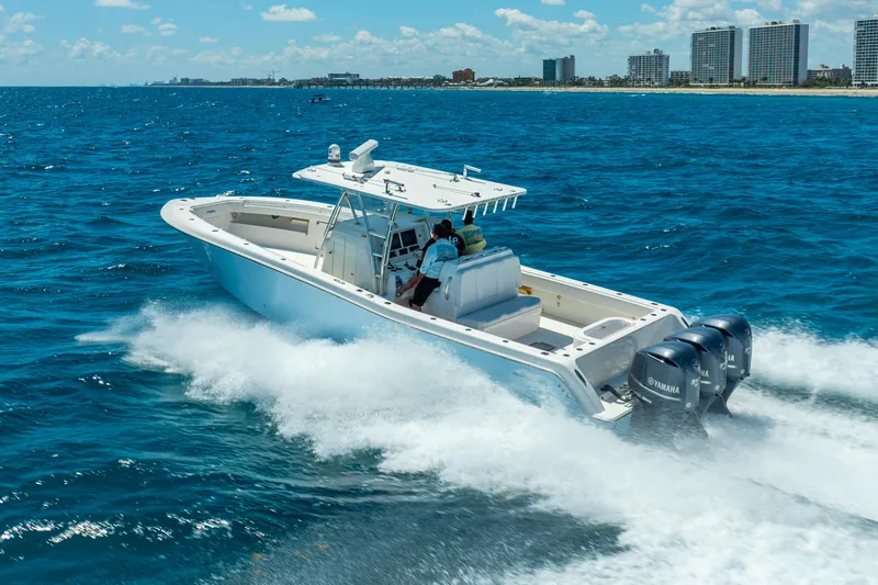 Slide: The Image of 2016 Invincible 39 boat cruising on ocean near city skyline. - 8