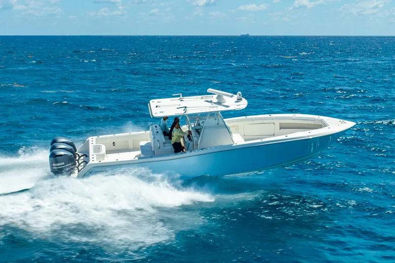 Slide: The Image of 2016 Invincible 39 boat cruising on open ocean with clear blue skies. - 9