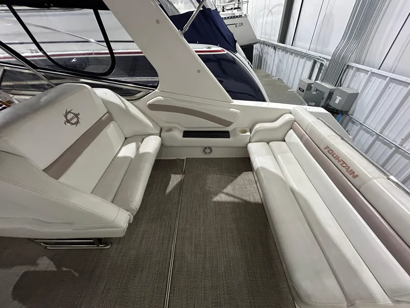 Slide: The Image of 2002 Fountain 38 Express Cruiser interior with white seating and carpeted floor. - 10