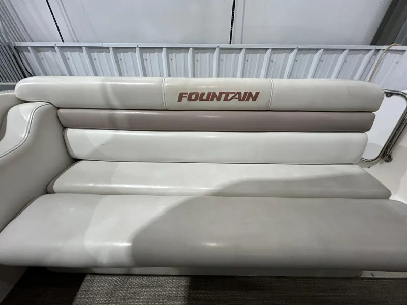 Slide: The Image of 2002 Fountain 38 Express Cruiser boat seat with logo in a storage area. - 11