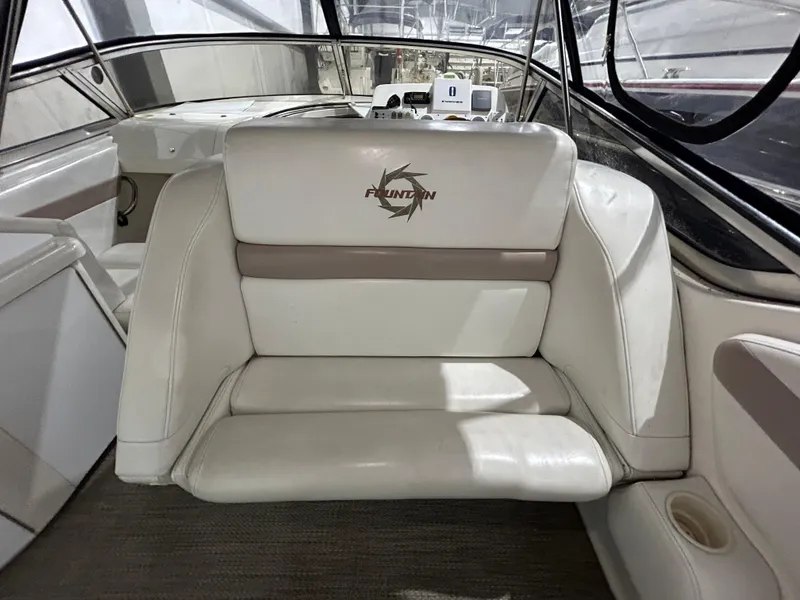 Slide: The Image of 2002 Fountain 38 Express Cruiser interior with white seating and logo. - 13