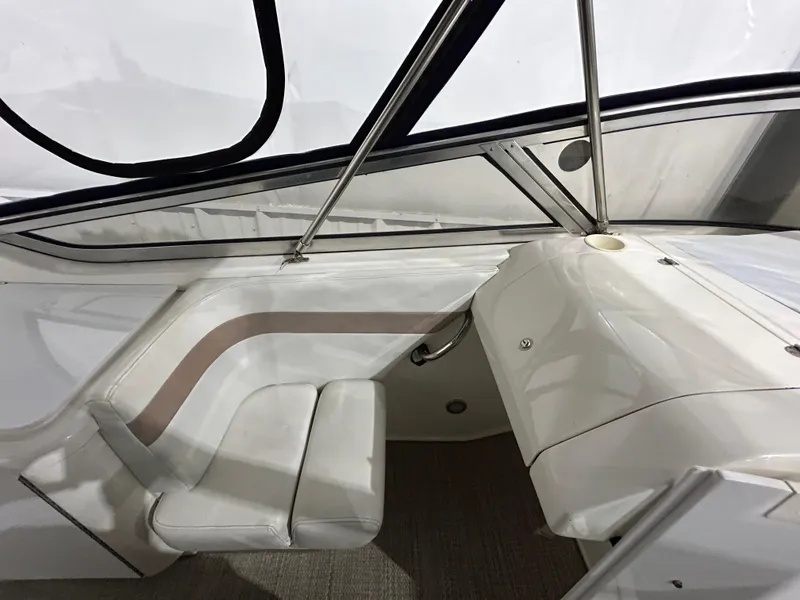 Slide: The Image of Interior of a 2002 Fountain 38 Express Cruiser, featuring sleek white seating and modern design. - 16