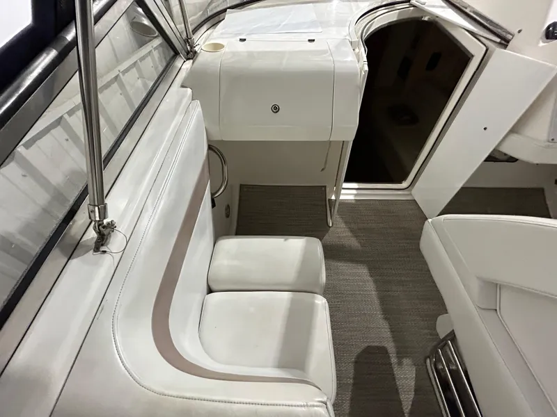 Slide: The Image of 2002 Fountain 38 Express Cruiser interior with white seating and open cabin door. - 17