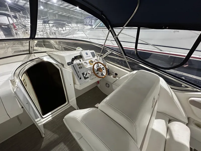 Slide: The Image of 2002 Fountain 38 Express Cruiser cockpit with steering wheel and seating. - 18