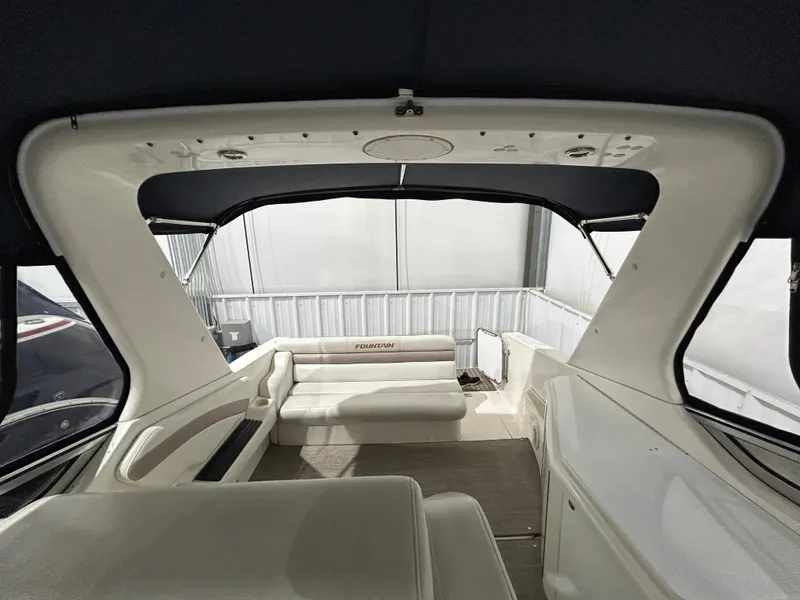 Slide: The Image of Interior view of 2002 Fountain 38 Express Cruiser with white seating and canopy. - 20