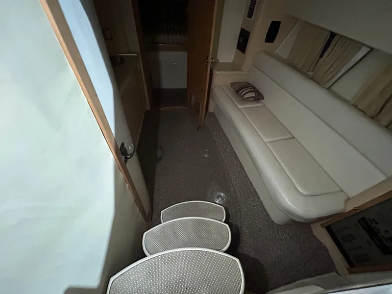 Slide: The Image of Interior of 2002 Fountain 38 Express Cruiser with white seating and carpeted steps. - 22