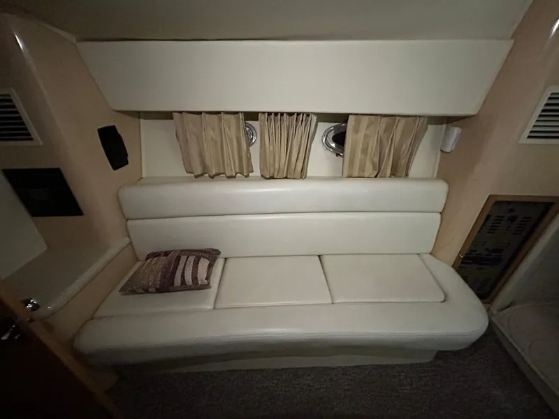 Slide: The Image of Interior of 2002 Fountain 38 Express Cruiser with white leather seating and striped pillow. - 23