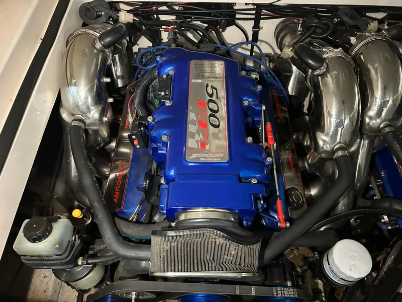 Slide: The Image of Engine of a 2002 Fountain 38 Express Cruiser, featuring a blue Mercury 500 EFI motor. - 29