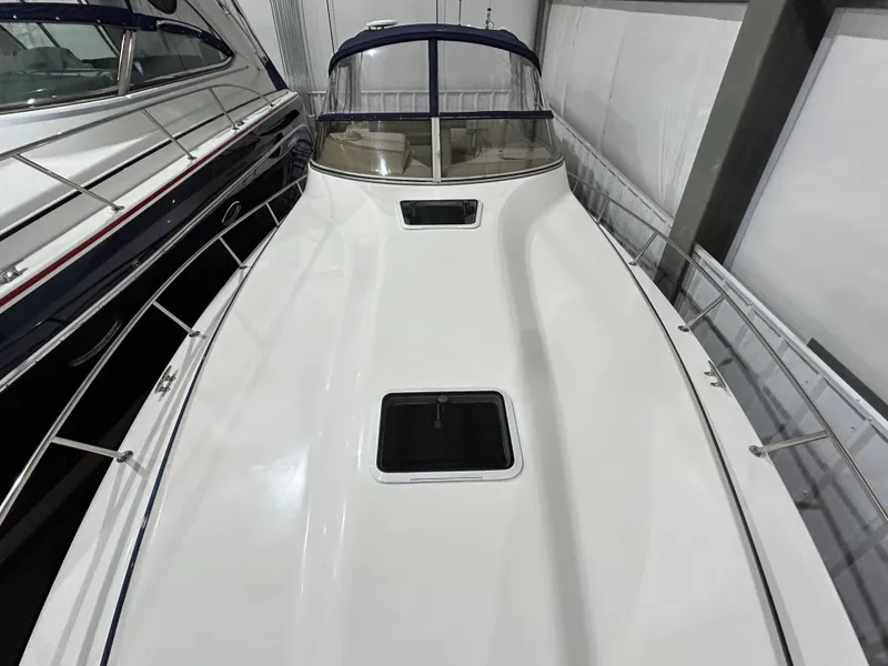 Slide: The Image of 2002 Fountain 38 Express Cruiser, white deck, docked indoors, sleek design. - 5