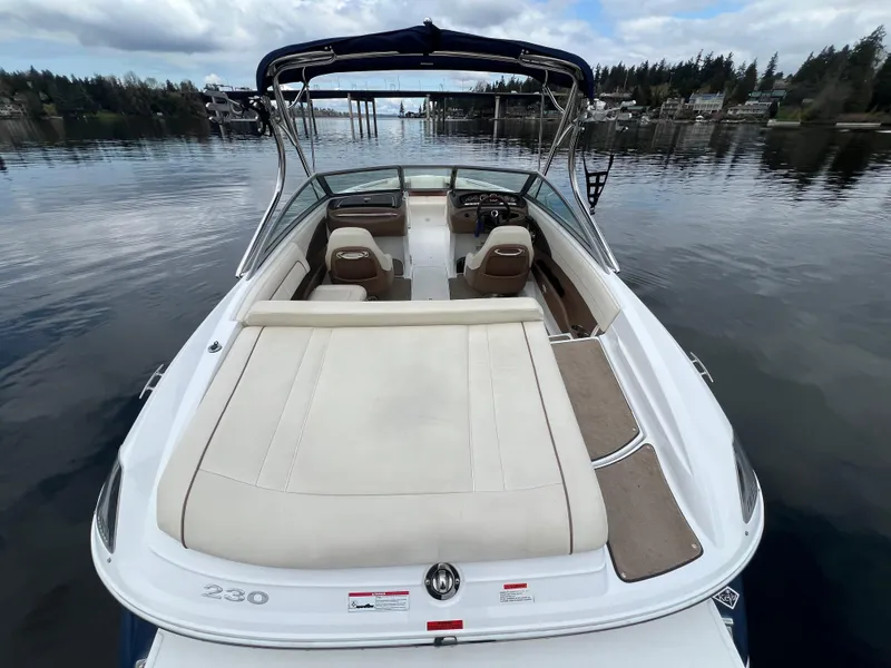 Slide: The Image of 2009 Cobalt 230 boat on calm water, featuring spacious seating and sleek design. - 12