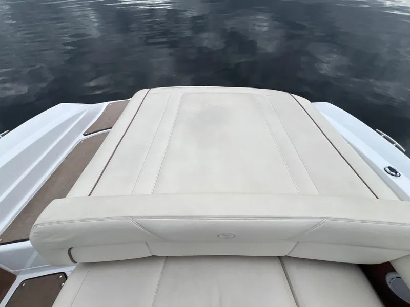 Slide: The Image of Rear view of a 2009 Cobalt 230 boat with beige upholstery. - 14