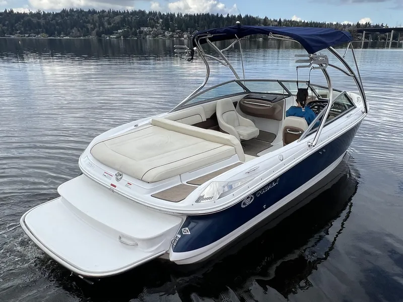 Slide: The Image of 2009 Cobalt 230 boat on calm lake with scenic forest background. - 6
