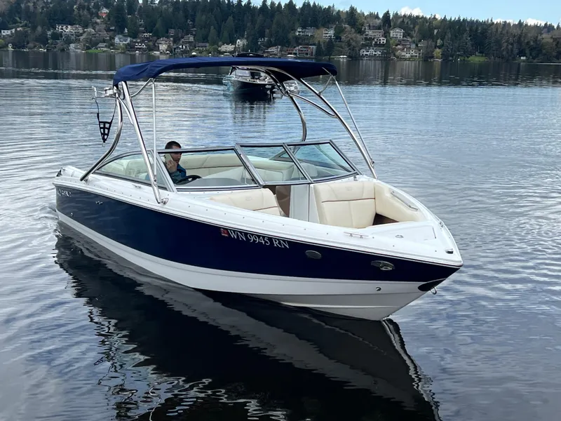Slide: The Image of 2009 Cobalt 230 boat on a calm lake with scenic background. - 8