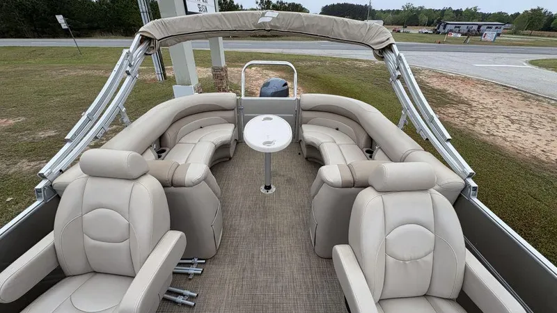 Slide: The Image of 2016 Starcraft EX23 R pontoon boat with beige seating and central table. - 10