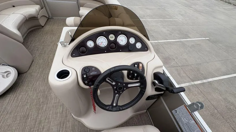 Slide: The Image of 2016 Starcraft EX23 R boat dashboard with steering wheel and gauges. - 12