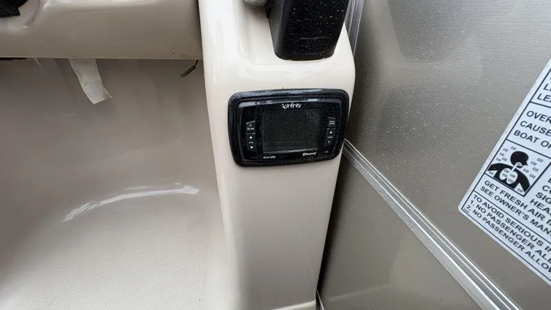 Slide: The Image of 2016 Starcraft EX23 R boat dashboard with Infinity Bluetooth stereo system. - 14