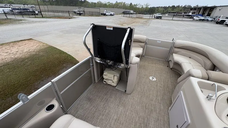 Slide: The Image of 2016 Starcraft EX23 R pontoon boat interior with beige seating and open deck layout. - 15