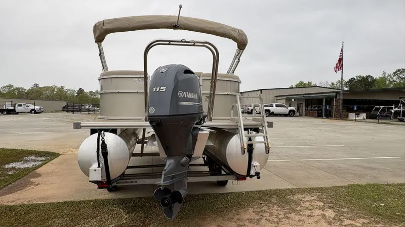 Slide: The Image of 2016 Starcraft EX23 R pontoon boat with Yamaha 115 outboard motor in a parking lot. - 3