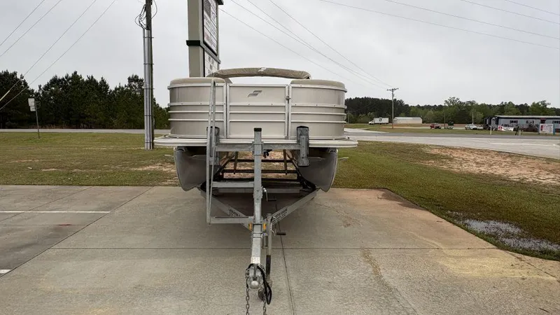 Slide: The Image of 2016 Starcraft EX23 R pontoon boat on trailer in parking lot. - 4