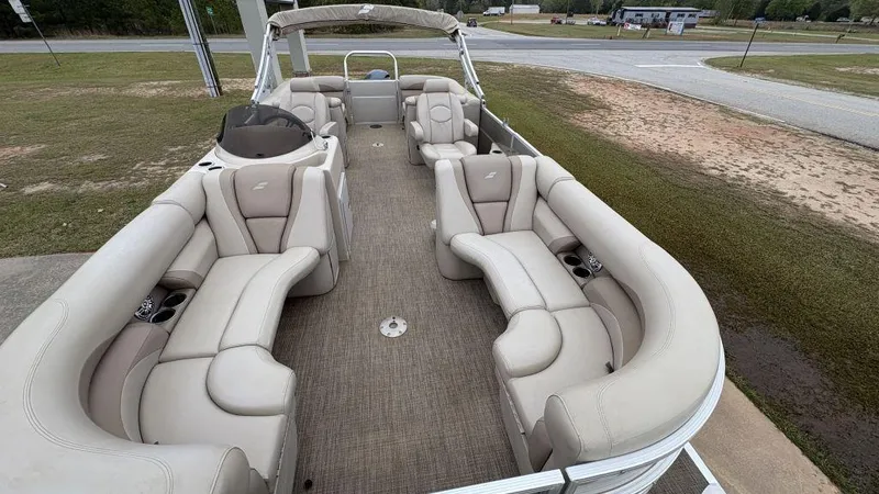 Slide: The Image of 2016 Starcraft EX23 R pontoon boat with spacious beige seating and open deck layout. - 5