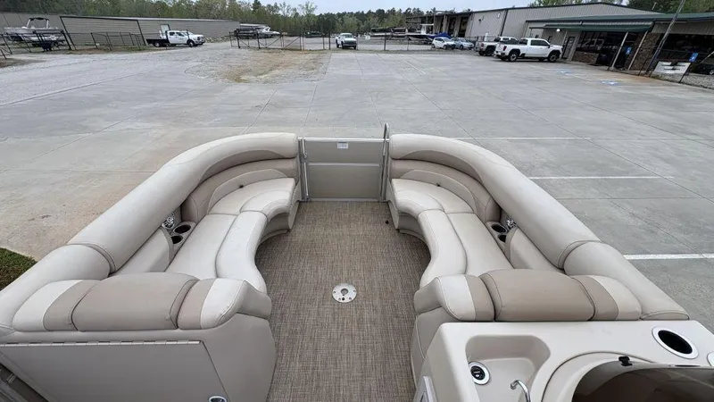 Slide: The Image of 2016 Starcraft EX23 R pontoon boat with beige seating in a parking lot. - 7
