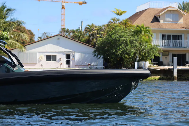 Slide: The Image of Skipper-BSK 38 boat on water near waterfront homes, 2025 model. - 4