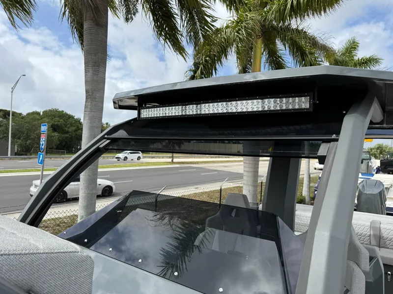Slide: The Image of 2025 Skipper-BSK 38 boat with LED light bar, parked near palm trees. - 18