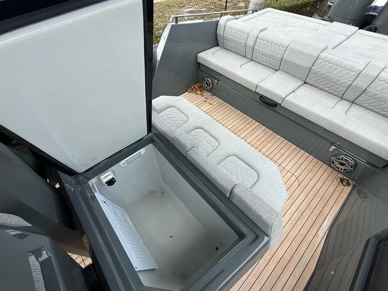 Slide: The Image of 2025 Skipper-BSK 38 boat interior with open storage and cushioned seating. - 24