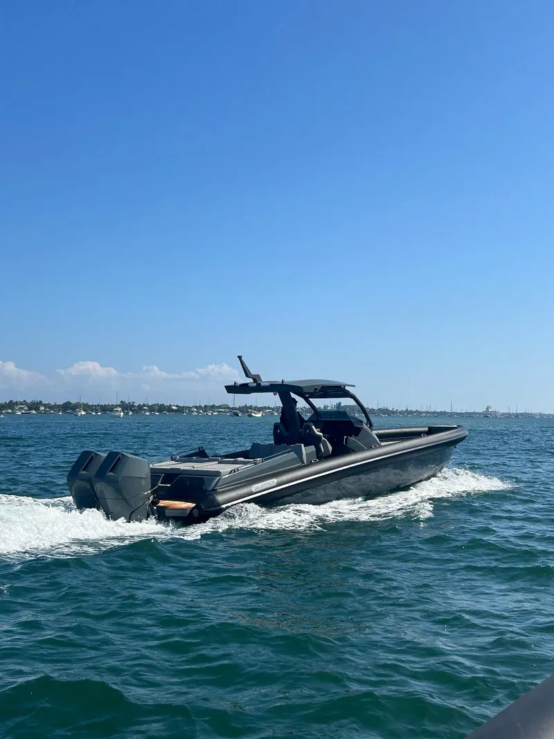 Slide: The Image of 2025 Skipper-BSK 38 boat cruising on open water under clear blue sky. - 4