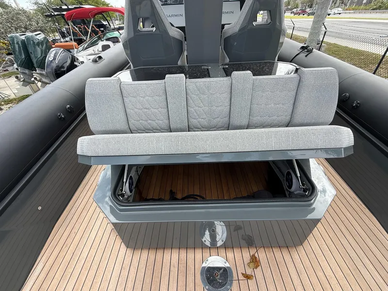 Slide: The Image of 2025 Skipper-BSK 38 boat with open storage compartment and cushioned seating on deck. - 28