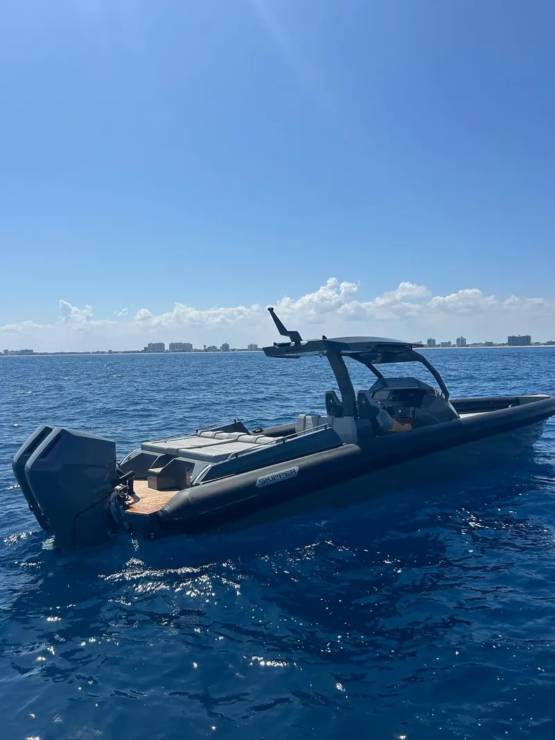 Slide: The Image of 2025 Skipper-BSK 38 boat on open sea under clear blue sky. - 9