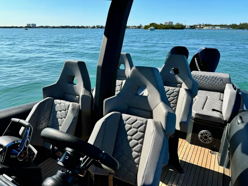 Slide: The Image of 2025 Skipper-BSK 34 boat interior with modern seating on a sunny day. - 10