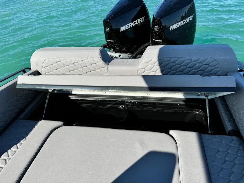 Slide: The Image of 2025 Skipper-BSK 34 boat with dual Mercury engines on a sunny day. - 16