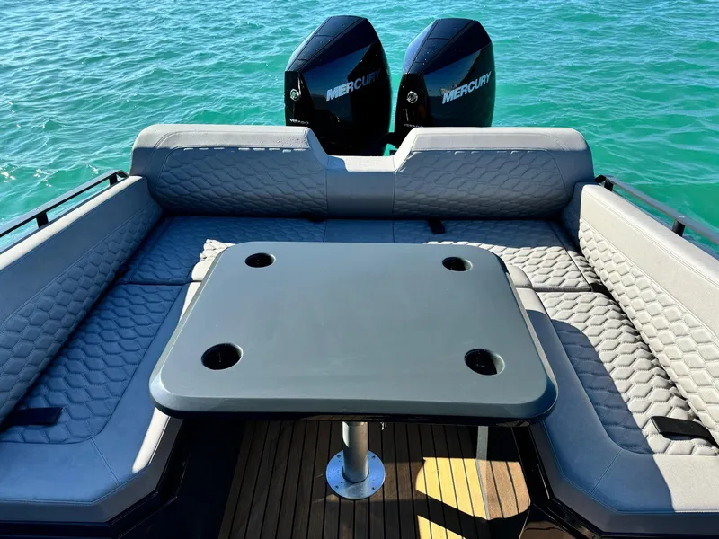 Slide: The Image of Luxurious Skipper-BSK 34 boat interior with seating and table, 2025 model, on clear blue water. - 21