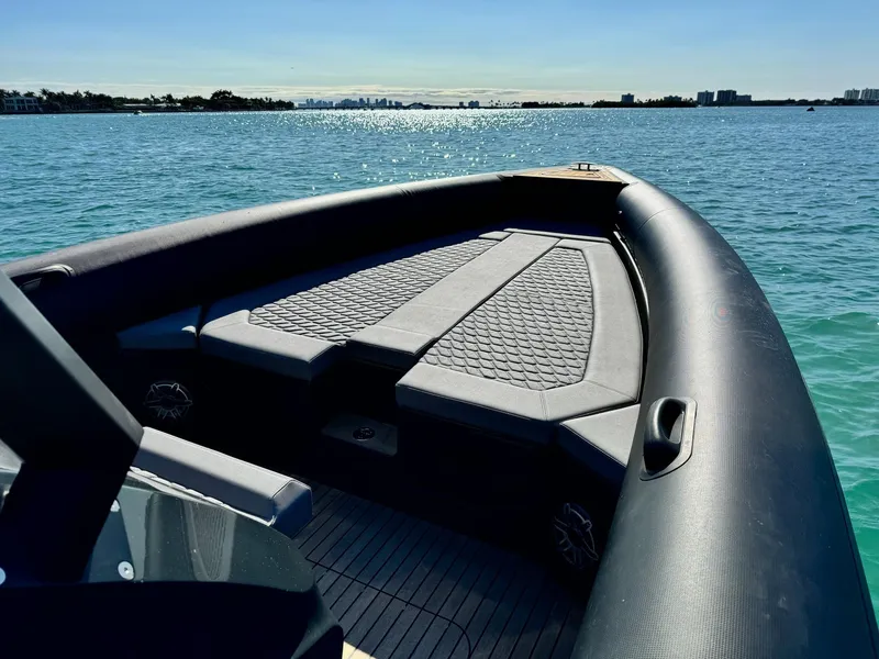 Slide: The Image of 2025 Skipper-BSK 34 boat on calm water, showcasing sleek design and spacious deck. - 3