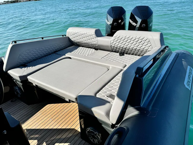 Slide: The Image of Luxurious Skipper-BSK 34 boat interior with cushioned seating, 2025 model, on a sunny day. - 11