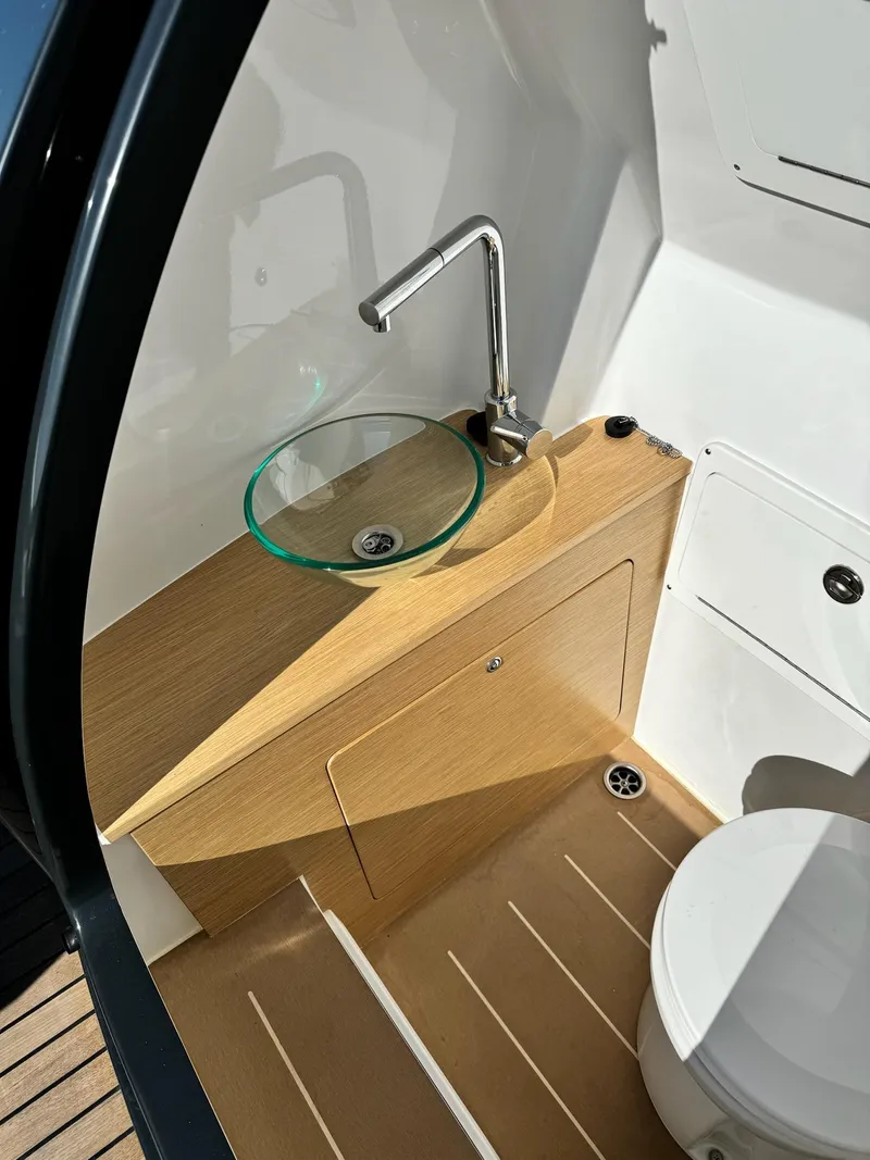 Slide: The Image of Modern Skipper-BSK 34 boat bathroom with glass sink and wooden accents, 2025 model. - 5