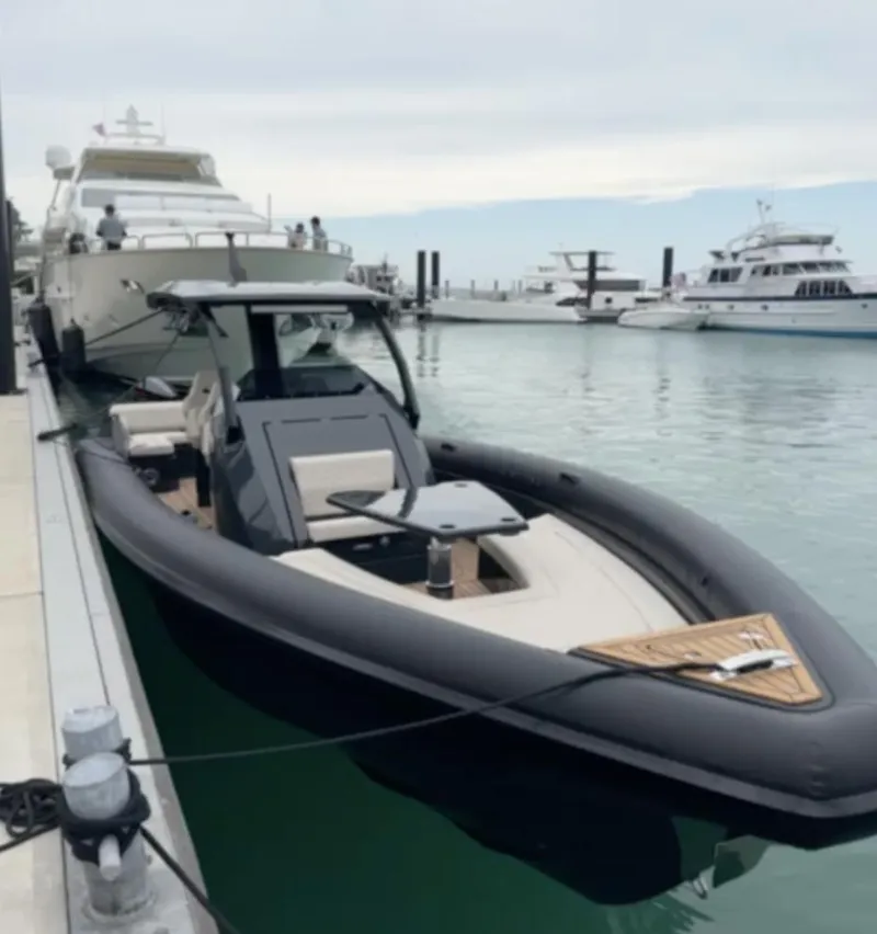 Slide: The Image of 2024 Skipper-BSK 38 luxury boat docked in a marina with other yachts. - 3