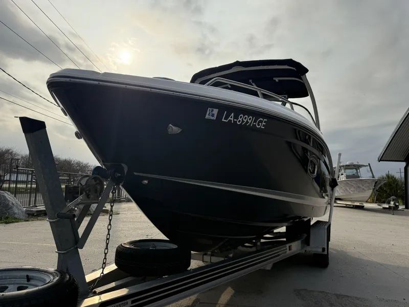 Slide: The Image of 2015 Chaparral 257 SSX boat on trailer under cloudy sky. - 11