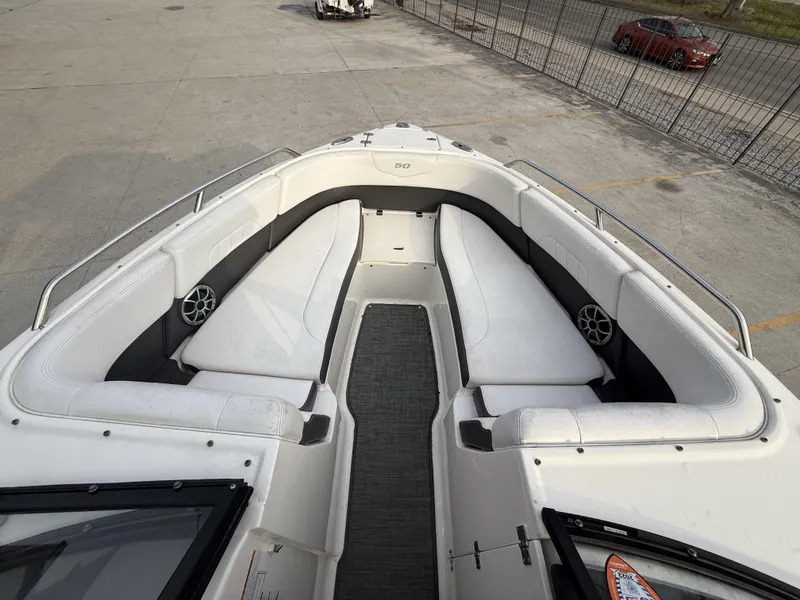 Slide: The Image of 2015 Chaparral 257 SSX boat interior with white seating and speakers. - 14