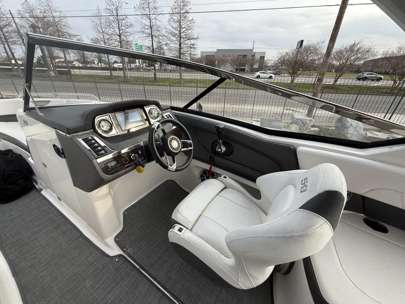 Slide: The Image of 2015 Chaparral 257 SSX boat interior with steering wheel and dashboard controls. - 7