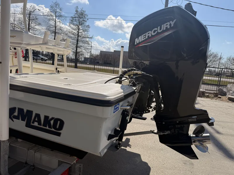 Slide: The Image of 2021 Mako 18 LTS boat with Mercury outboard motor, parked outdoors. - 12