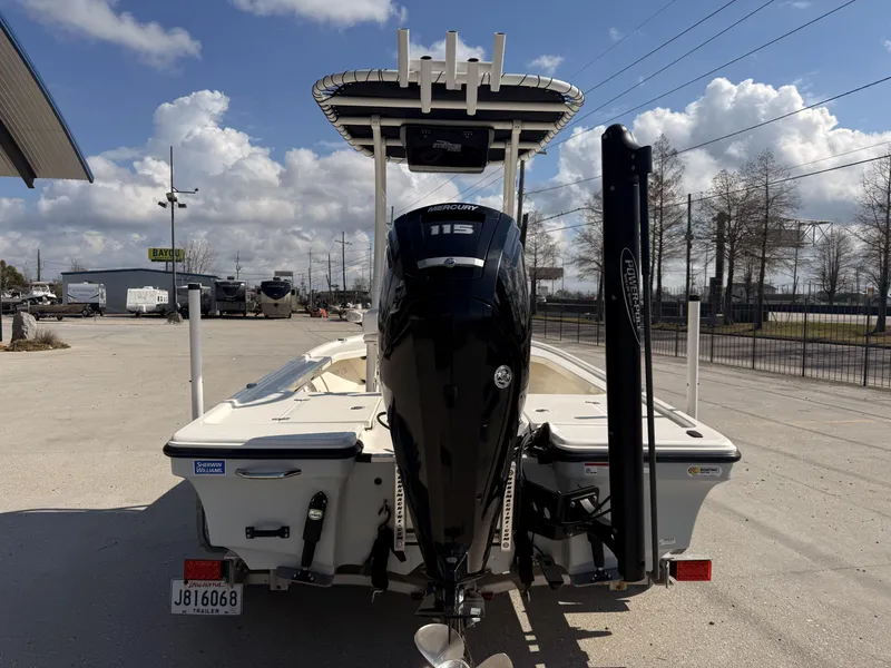 Slide: The Image of 2021 Mako 18 LTS boat with Mercury 115 engine, parked outdoors under cloudy sky. - 6