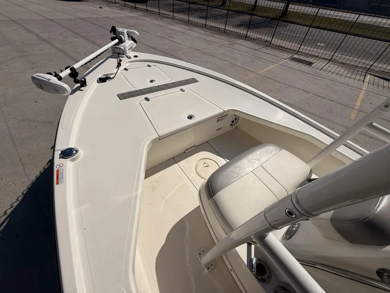 Slide: The Image of 2021 Mako 18 LTS boat interior with seating and trolling motor. - 9
