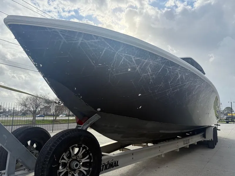 Slide: The Image of 2006 SeaHunter 41 CC Offshore Center Console boat on trailer under cloudy sky. - 12