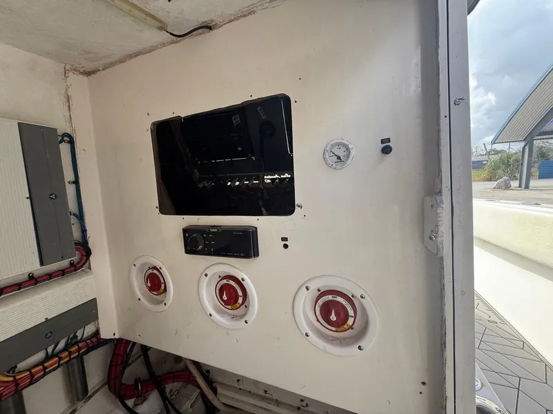 Slide: The Image of Control panel of 2006 SeaHunter 41 CC Offshore Center Console boat, featuring gauges and switches. - 20