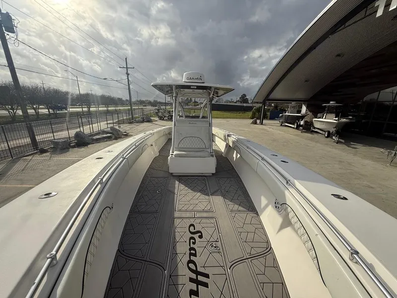 Slide: The Image of 2006 SeaHunter 41 CC Offshore Center Console boat docked under cloudy skies. - 26