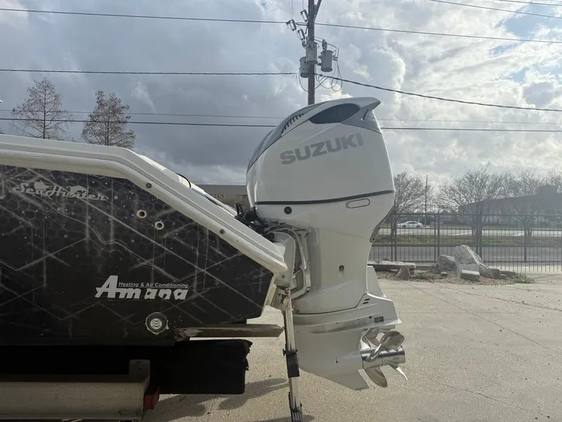 Slide: The Image of 2006 SeaHunter 41 CC Offshore boat with Suzuki outboard motor, parked outdoors. - 8